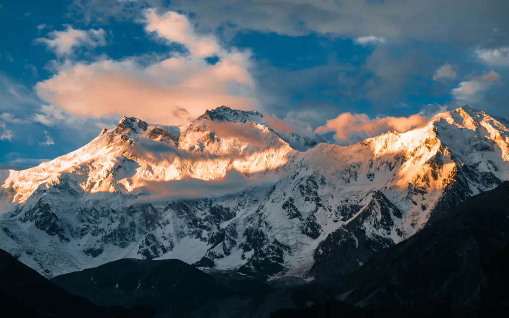 Sunrise lighting the snowy face of Nanga Parbat, the peak above Fairy Meadows