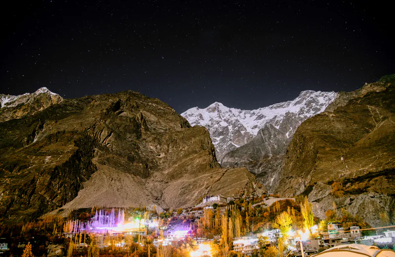 Karimabad village lit up at night under the stars